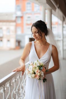 preparations for the bride with the dressing of the wedding dress in the studio