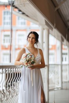 preparations for the bride with the dressing of the wedding dress in the studio