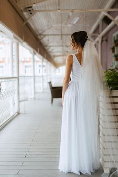 preparations for the bride with the dressing of the wedding dress in the studio