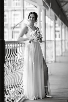 preparations for the bride with the dressing of the wedding dress in the studio