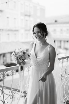 preparations for the bride with the dressing of the wedding dress in the studio