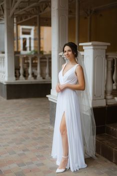 preparations for the bride with the dressing of the wedding dress in the studio