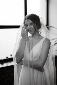 preparations for the bride with the dressing of the wedding dress in the studio