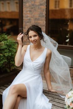 preparations for the bride with the dressing of the wedding dress in the studio