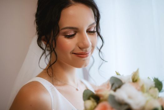 preparations for the bride with the dressing of the wedding dress in the studio