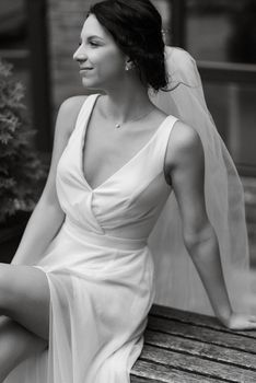 preparations for the bride with the dressing of the wedding dress in the studio