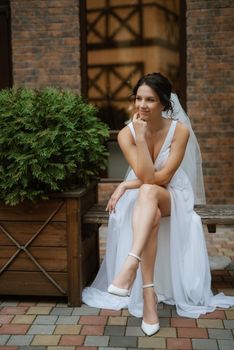 preparations for the bride with the dressing of the wedding dress in the studio