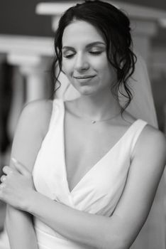 preparations for the bride with the dressing of the wedding dress in the studio