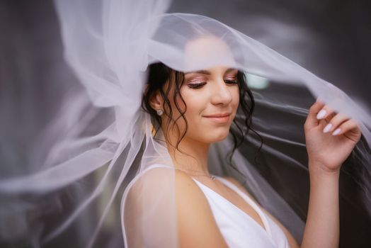 preparations for the bride with the dressing of the wedding dress in the studio