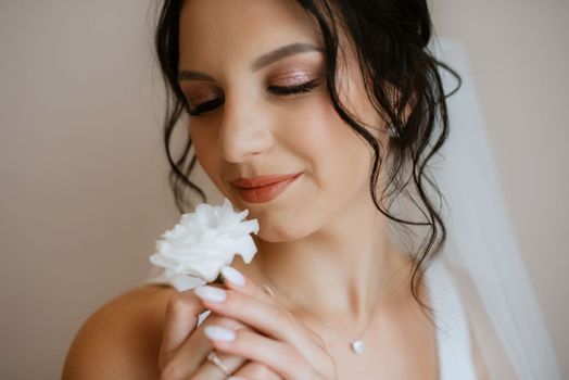 preparations for the bride with the dressing of the wedding dress in the studio