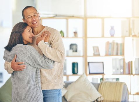 Love, romance and married with a couple hugging while standing in their home together with mockup or flare. Affection, bonding and hug with a mature man and woman embracing in their domestic house.
