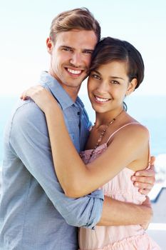 Young couple embracing. Portrait of happy young couple embracing each other outdoors