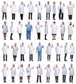 full length group of doctors showing badge isolated on white background