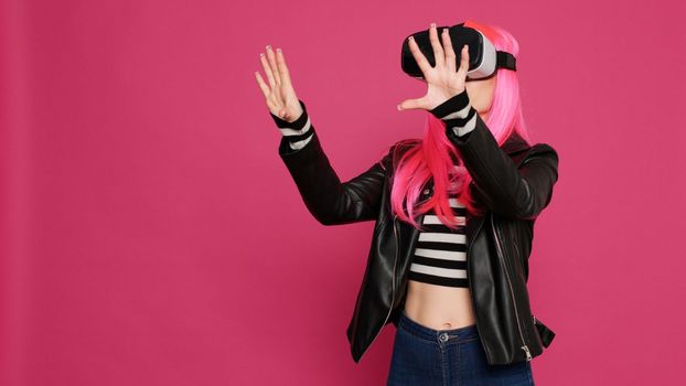 Beautiful cool person using vr goggles with augmented reality tech, futuristic interactive wireless glasses. Young pretty adult having fun with simulator and 3d innovation, electronic system.