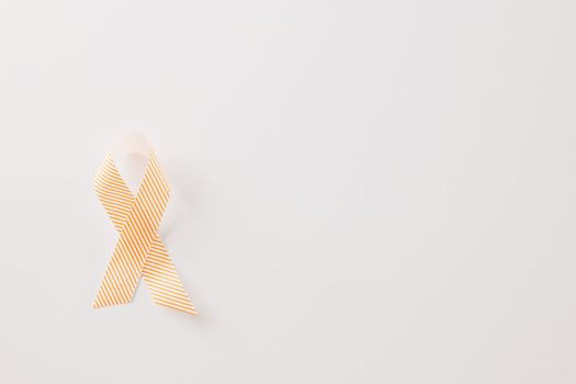 Close up pink awareness ribbon of International World Cancer Day campaign isolated on white background with copy space, concept of medical and health care support, 4 February
