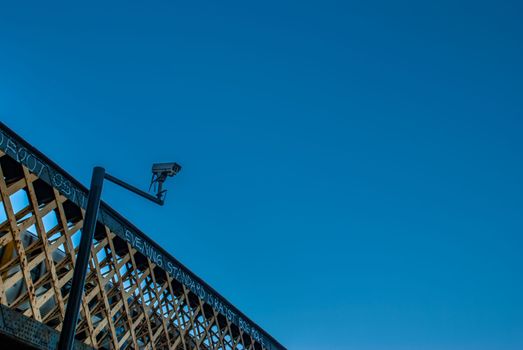 London, UK - Feb 25, 2019 : Modern CCTV on the wall, background, bridge and sky The concept of surveillance and visual inspection that has been developed