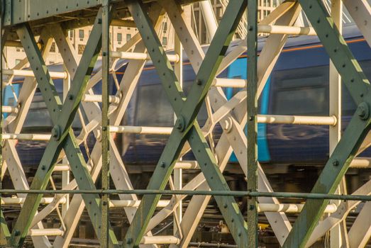 Fast Moving Train and Platform Behind Metal Fence in London