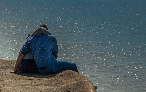 Beautiful Couple of lovers on the Bank of a river. Lovers sit on the river Bank.