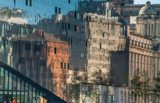 building reflected on glass facade wall of building Beautiful and strange patterns. Architecture concept.