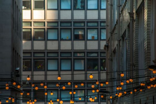 Outdoor decorative string lights hanging in front of the building in the evening Suitable for background images.