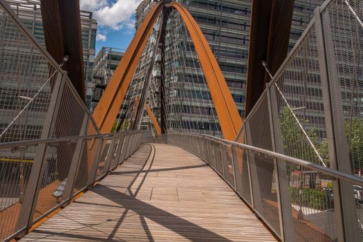 London 7 Jun 62 - A bridge towards a modern looking building. building and the bridge which are situated in a business park.