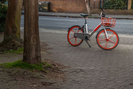 London, UK - Feb 22, 2019 : Red Bike Silver on the road, isolated on the road in London