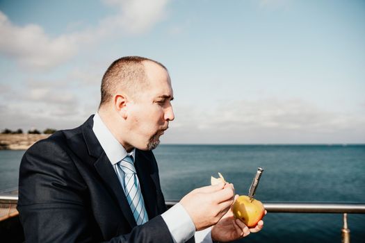 Young business people eating golden apples in lunch time discussing phone calls