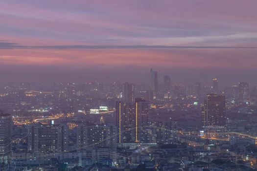 Bangkok, thailand - Dec 23, 2020 : Looking through the window mirror to see The cityscape of Bangkok with skyscrapers and bright glowing lights at night. Focus and blur.