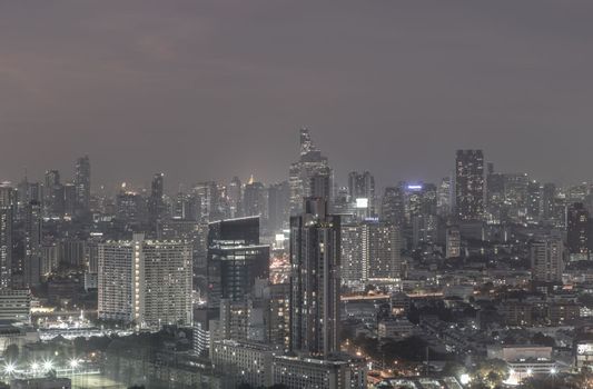 Bangkok, thailand - Dec 23, 2020 : Bangkok downtown cityscape in Business district with bright glowing lights at night give the city a modern style. Dark tone, No focus, specifically.