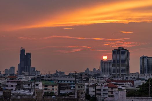 Bangkok, Thailand - 11 Apr, 2020 : Skyscrapers Bangkok City in the light of the setting sun silhouetted cities at sunset. Beautiful sunset over office building center. Selective focus.
