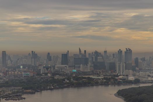 Bangkok, Thailand - Jun 19, 2020 : City view of Bangkok with Chao Phraya River curve. Lonely moment of the sunset. Selective focus.