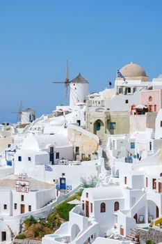 Oia Santorini Greece on a sunny day during summer with whitewashed homes and churches, Greek Island Aegean Cyclades on a sunny day with blue ocean