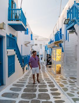 Mykonos Greece April 2018, Tourists at the streets of the Greek village in Greece, colorful streets of Mikonos village.