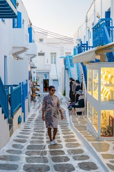 Mykonos Greece April 2018, Tourists at the streets of the Greek village in Greece, colorful streets of Mikonos village.