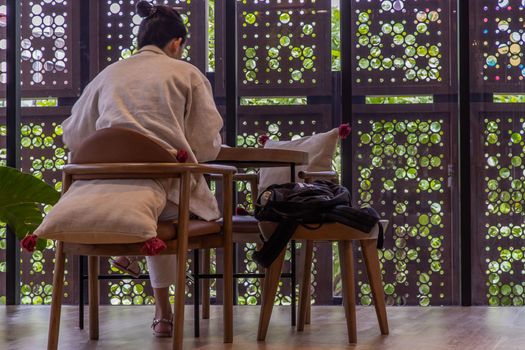 Bangkok, Thailand, Jul 04, 2020 : work from home concept. Social distancing concept. A lady is working in co-working space. Selective focus.