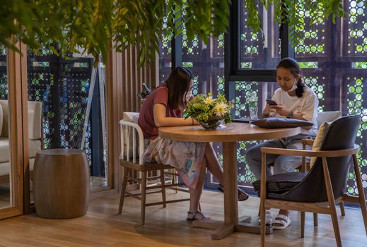 Bangkok, Thailand, Jul 04, 2020 : A meeting of two ladies in co-working space. New normal concept. Selective focus.