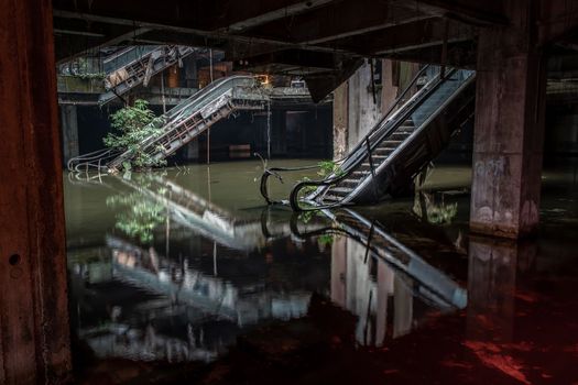 Bangkok, Thailand - 07 Feb 2022 : Damaged escalators and waterlogged in abandoned shopping mall building. Structural and ruins was left to deteriorate over time, New World Mall, Selective focus.