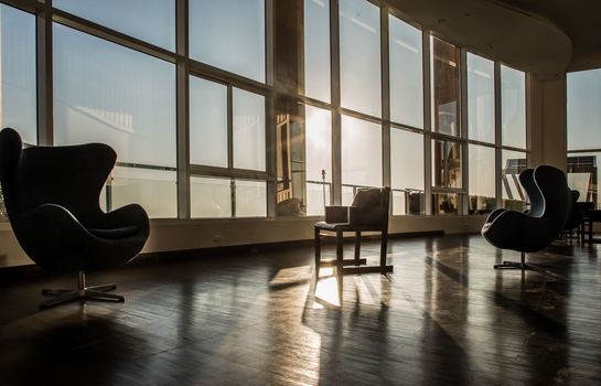 Bangkok, Thailand - Jan 10, 2022 : Common area of condominium in morning. New normal, The seats were set separately according to social distancing policy for the spread of covid-19 prevention, Selective focus.