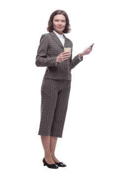 modern business woman with a smartphone and takeaway coffee. isolated on a white background.