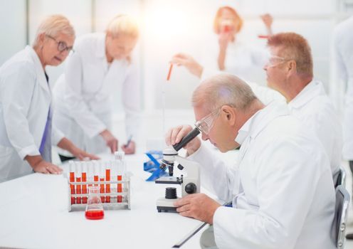 group of scientists conduct testing in the laboratory . concept of health protection.