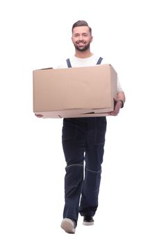 in full growth. smiling man carries a large cardboard box. photo with copy space