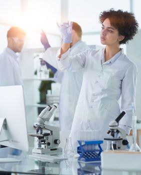 Team of Scientists Working Using Microscope, Analysing Microbiology Samples