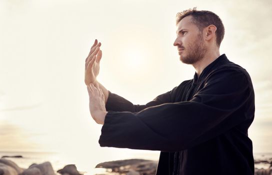 Man, hands or relax tai chi on sunset beach in fitness, workout or training in mental health, chakra energy or mind balance. Zen, martial arts or person by ocean sea, nature water or sunrise exercise.