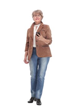Modern senior woman making selfie on smartphone against light studio background