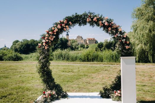 Wedding ceremony on the street on the green lawn near the Nesvizh Castle.Belarus.