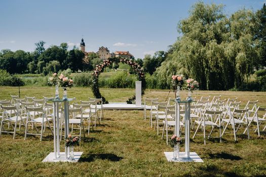 Wedding ceremony on the street on the green lawn near the Nesvizh Castle.Belarus.