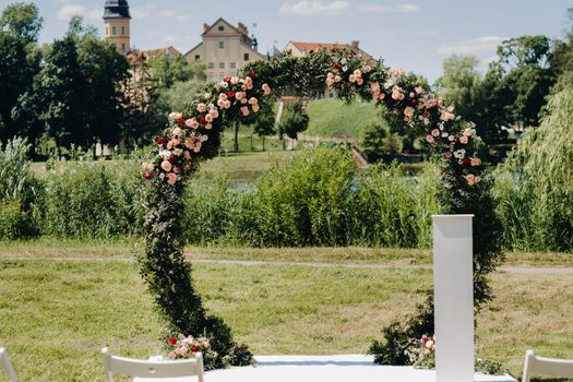Wedding ceremony on the street on the green lawn near the Nesvizh Castle.Belarus.