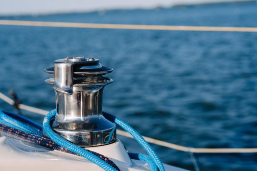 rope on the winch of a white yacht in the sea.yacht equipment.