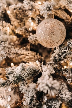 Christmas tree close-up. On New year's eve, a decorated snow-covered Christmas tree