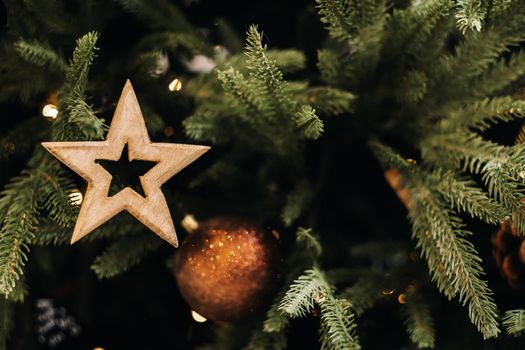 Christmas tree close-up with a star. Christmas tree is decorated on New year's eve.